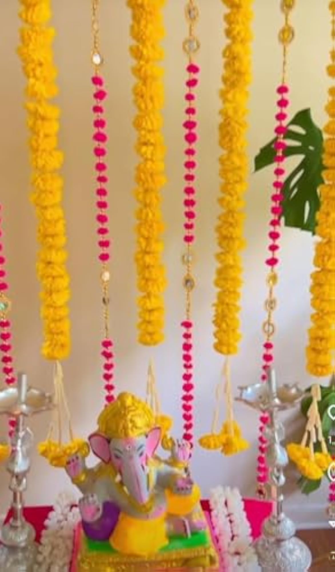 Decorative Ganpati Poojan Setup with Marigold Toran and Umbrellas